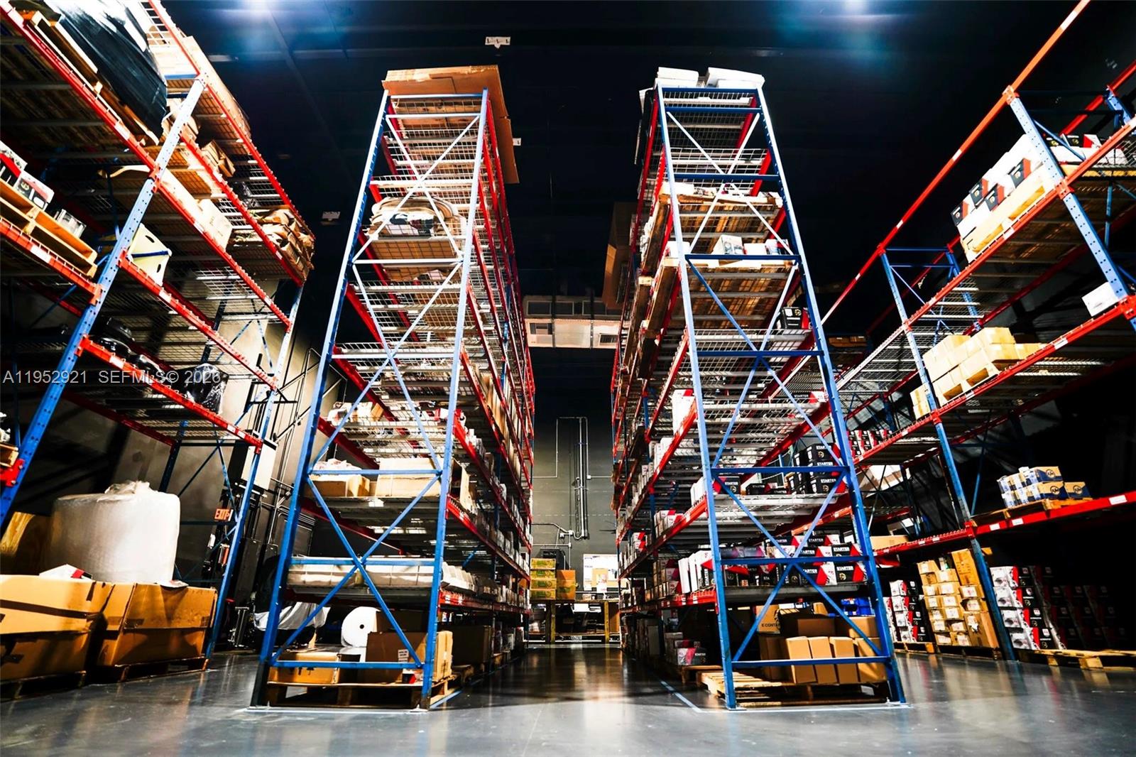 A warehouse interior features tall metal shelving units filled with various boxes and inventory — 7865 NW 46th St # 8, Doral FL 33166, DORAL, FL