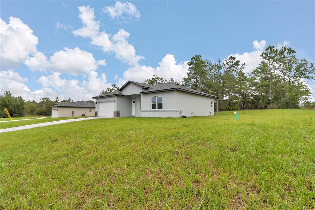 An aerial view of the rear exterior of a single-story house with a covered patio — 6202 N MARINER TERRACE, CITRUS SPRINGS, FL