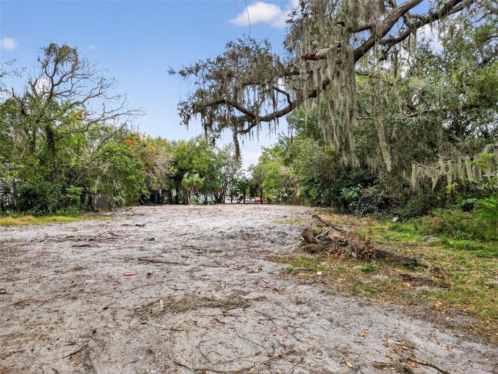A vacant, sandy lot is surrounded by mature trees with hanging Spanish moss — 6935 TURQUOISE LANE, ORLANDO, FL