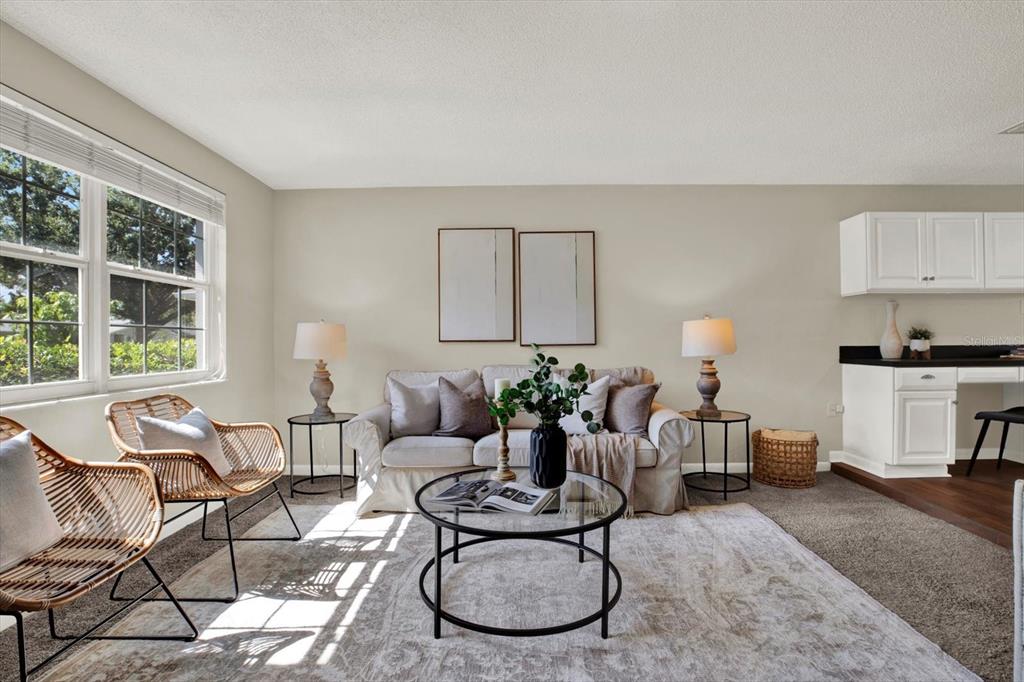 A living room features a sofa, two rattan chairs, a coffee table, and white cabinetry — 10898 119TH STREET N, SEMINOLE, FL