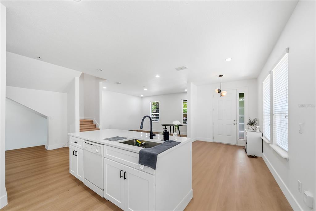 A view from a hallway looking into a bathroom and an adjacent living area — 10359 LAKE DISTRICT LANE UNIT 58B, ORLANDO, FL