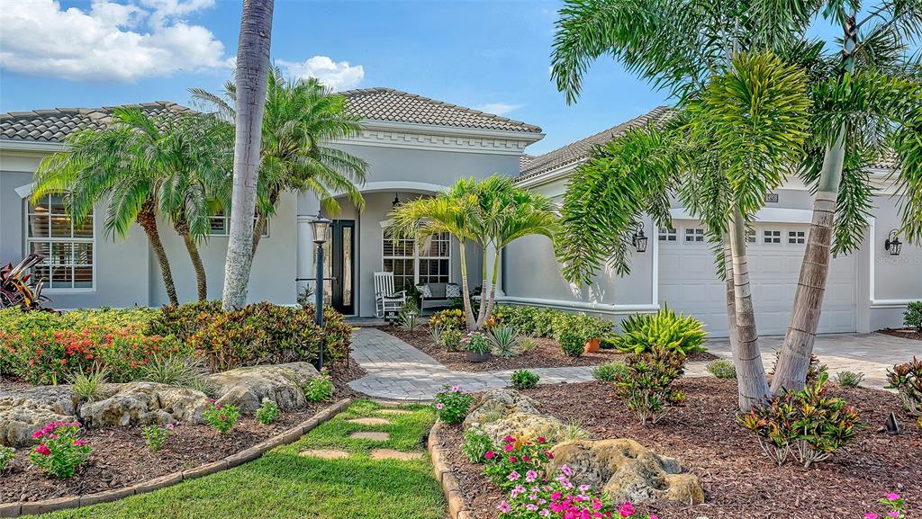 A single-story house with a gray exterior, a tiled roof, and a landscaped front yard — 14908 BOWFIN TERRACE, LAKEWOOD RANCH, FL