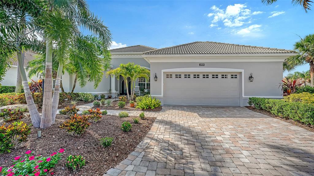 A single-story house with a gray exterior, a paved driveway, and palm trees in the front — 14908 BOWFIN TERRACE, LAKEWOOD RANCH, FL
