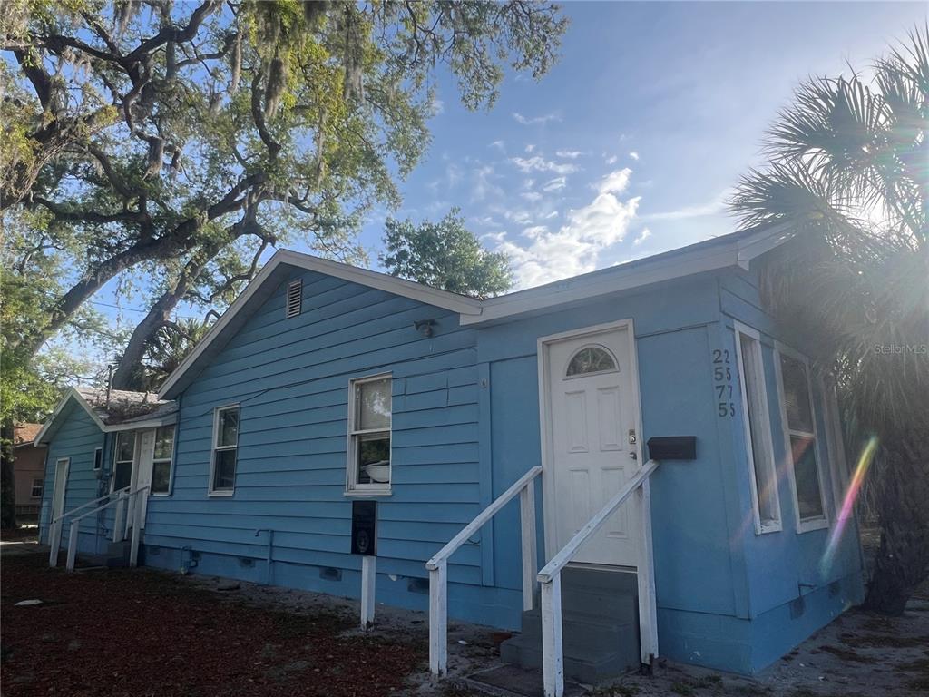 A blue, single-story house with white trim and a white front door stands outdoors — 2575 18TH AVENUE S, ST PETERSBURG, FL