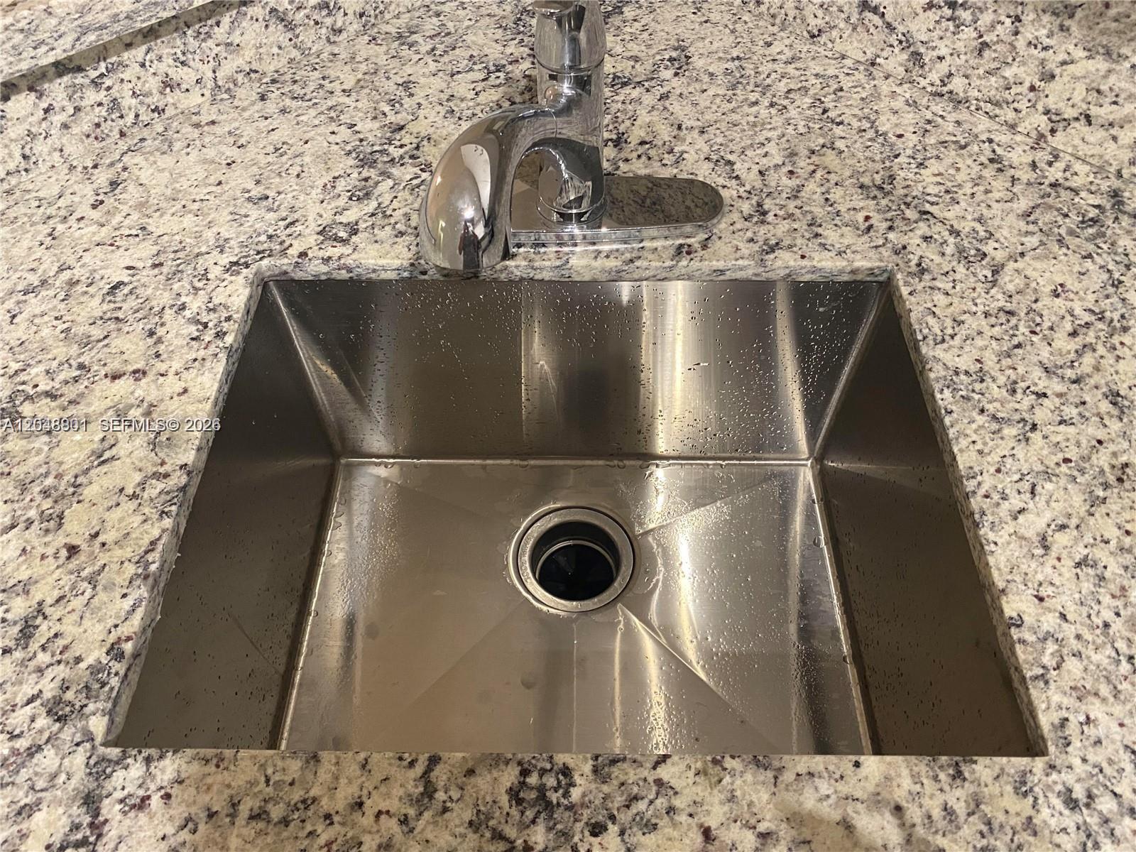 A stainless steel undermount sink is set into a speckled granite countertop — 11301 SW 17th Ct, Miramar FL 33025, MIRAMAR, FL