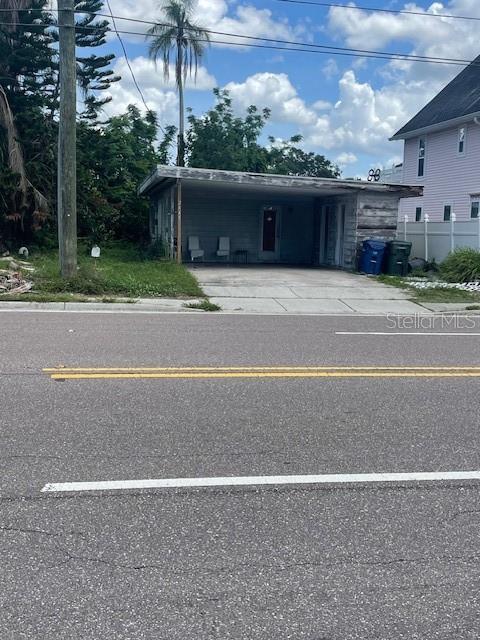 A single-story building with a carport sits next to a two-story house — 2445 WEBBER STREET, SARASOTA, FL