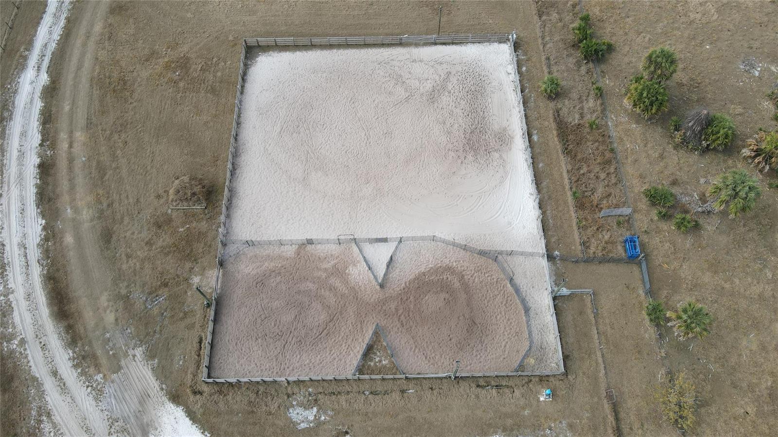 An aerial view shows a fenced equestrian riding arena with a smaller attached training pen — 4801 SW Wild Turkey Lane, Okeechobee FL 34974, OKEECHOBEE, FL