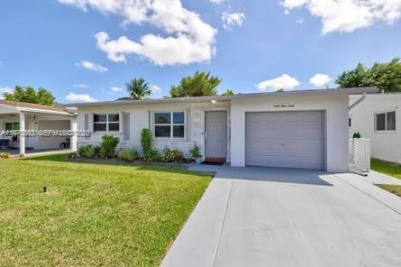 A single-story house with a white exterior, a garage, and a front lawn — 6960 NW 11th Ct, Margate FL 33063, MARGATE, FL