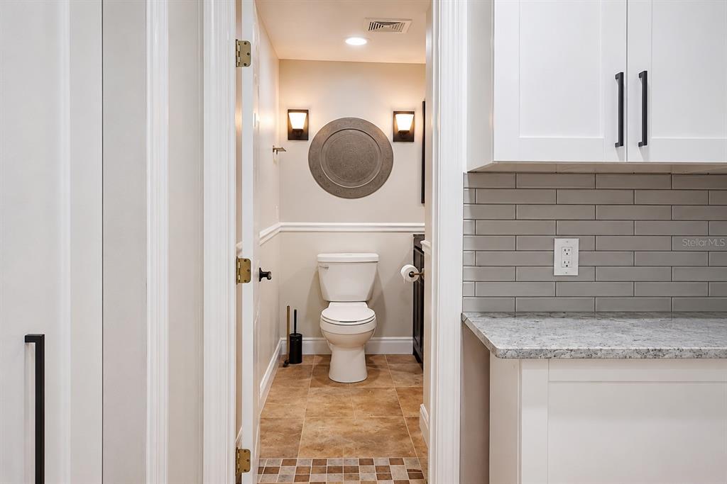 A view through a doorway into a small bathroom with a toilet and tiled floor — 2232 SELKIRK STREET, VALRICO, FL