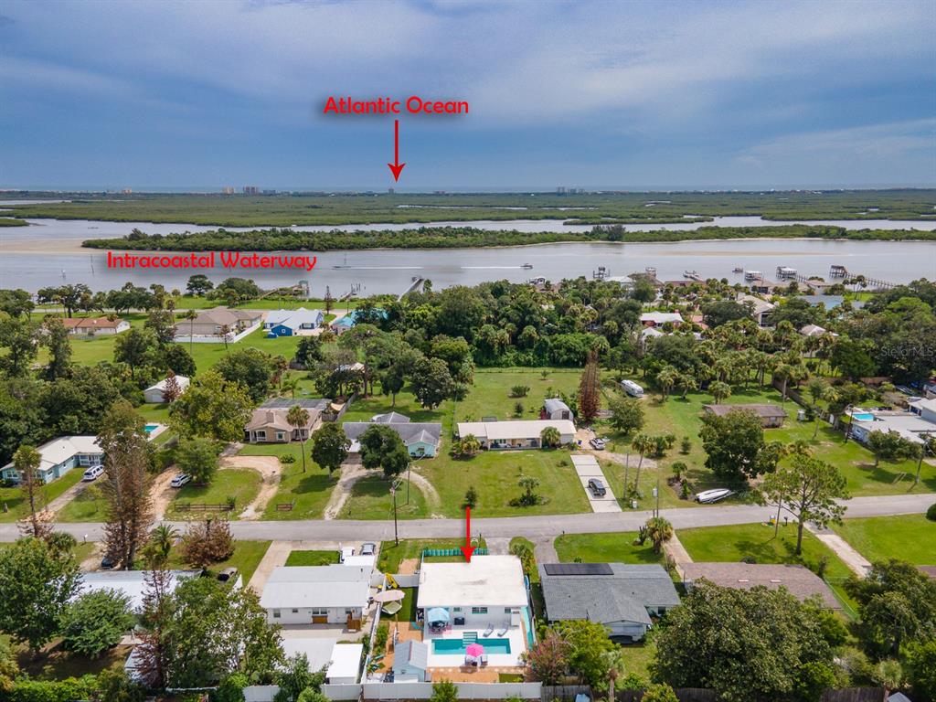 An aerial view shows a residential property with a pool near the Intracoastal Waterway — 926 FERNALD STREET, EDGEWATER, FL
