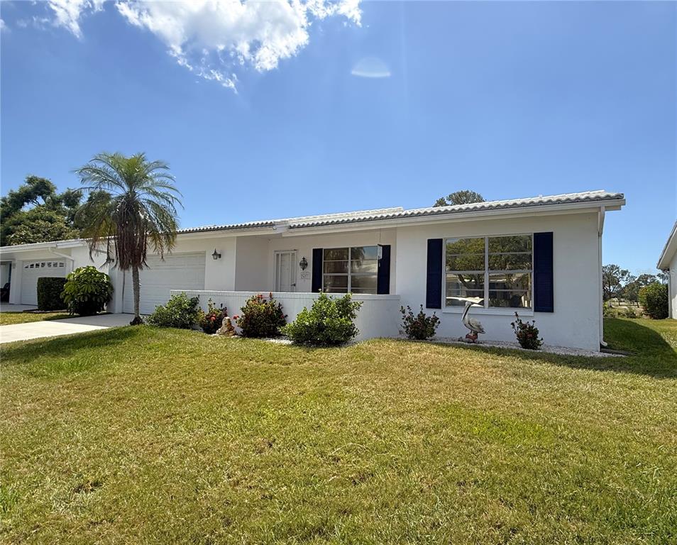 A single-story white house with a garage, palm tree, and front yard landscaping — 3455 MAINLANDS BOULEVARD S, PINELLAS PARK, FL