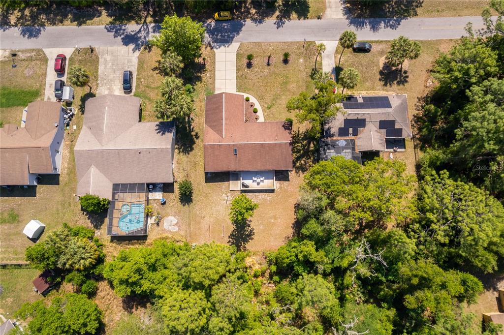 An aerial view shows three suburban houses with driveways, a swimming pool, and surrounding trees — 14604 SW 45TH COURT, OCALA, FL