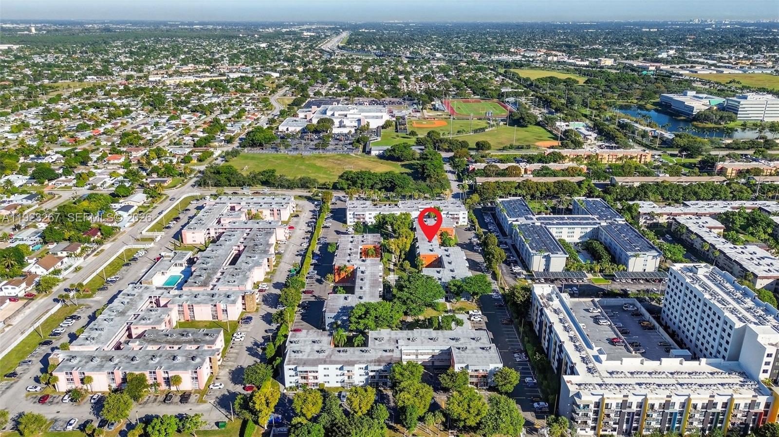 An aerial view shows a multi-story apartment complex with a red location pin — 11309 SW 200th St # C, Miami FL 33157, MIAMI, FL