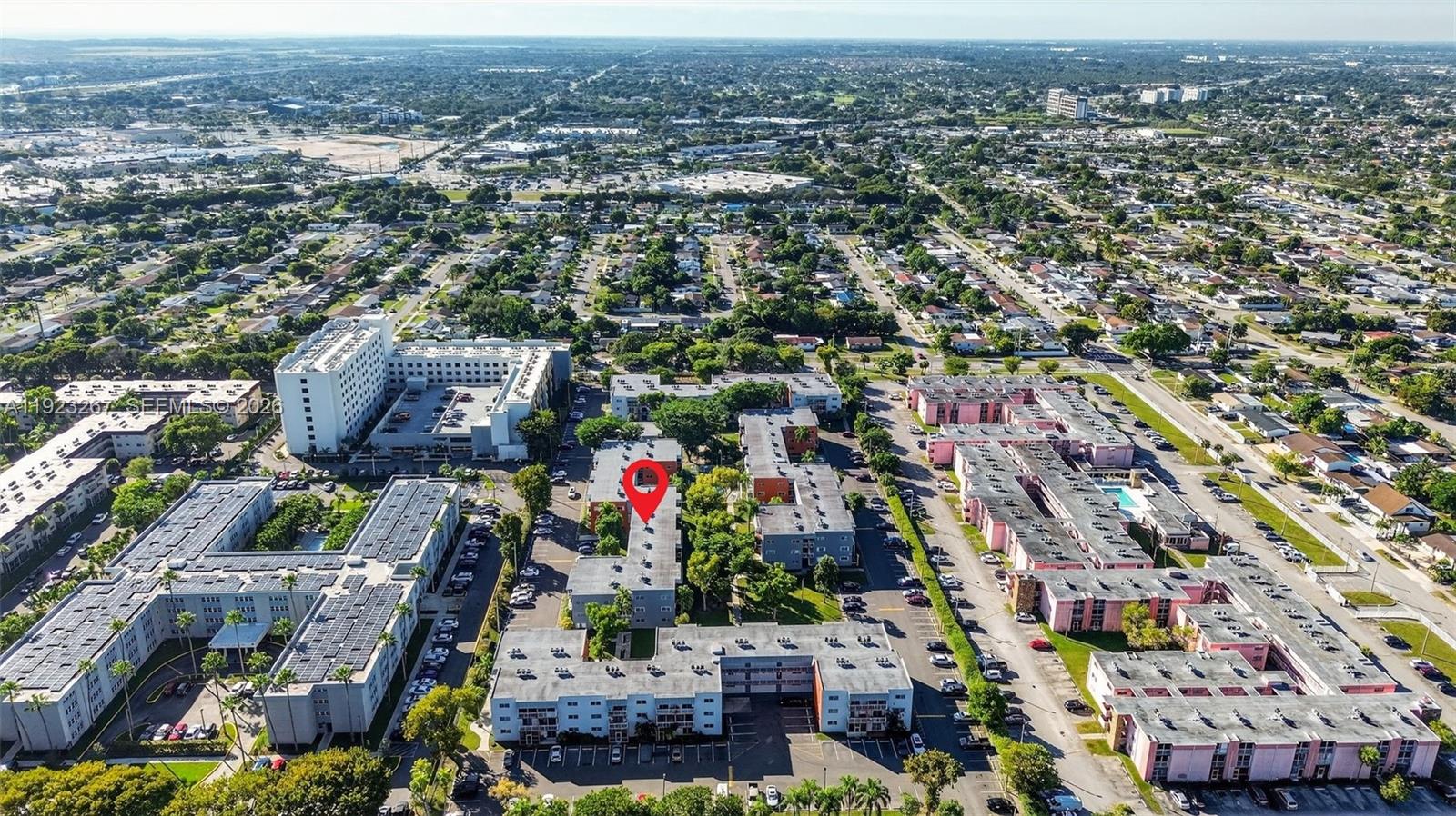 An aerial view shows a multi-story apartment complex with a red location pin — 11309 SW 200th St # C, Miami FL 33157, MIAMI, FL