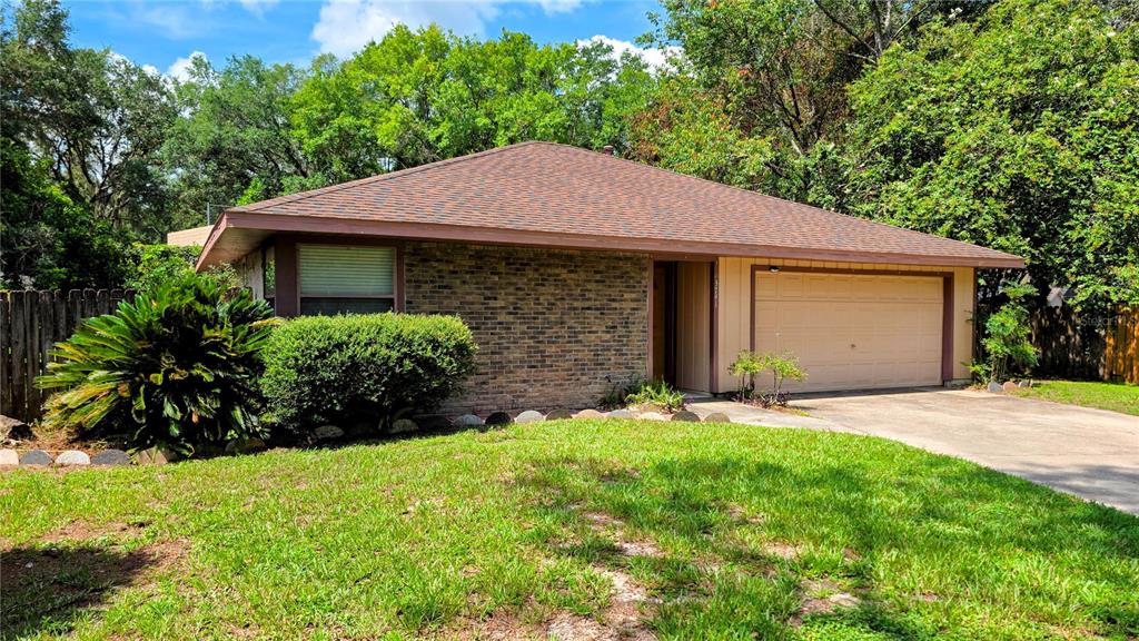 A single-story brick house with a brown roof and a two-car garage — 3741 NW 59TH PLACE, GAINESVILLE, FL