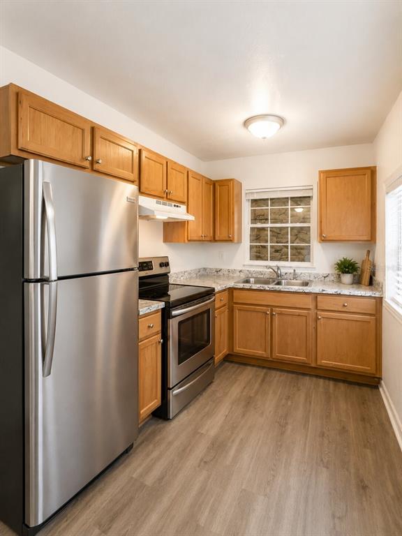 A kitchen with wood cabinets, stainless steel appliances, and light-colored countertops — 5527 BRYSON DRIVE, ORLANDO, FL