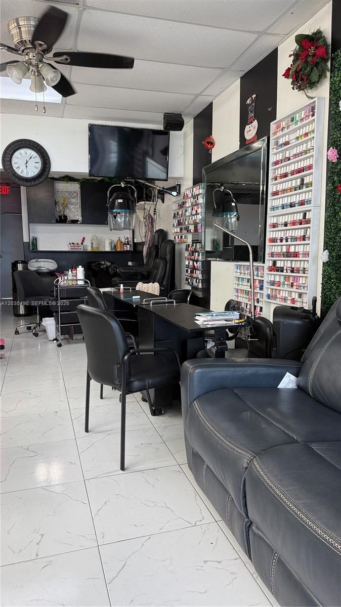 A salon interior features nail polish displays, manicure stations, black chairs, and a tiled floor — 11842 W Dixie Hwy, Miami FL 33161, MIAMI, FL