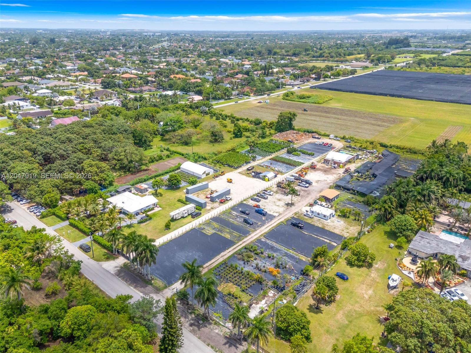 An aerial view shows a rural property with a house, nursery structures, and agricultural fields — 13770 SW 192nd St, Miami FL 33177, MIAMI, FL
