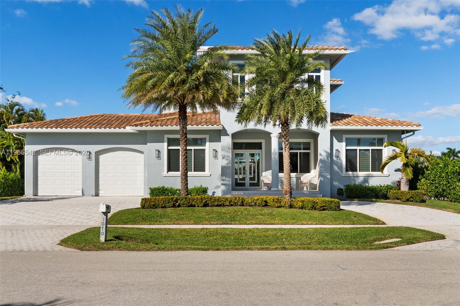 A two-story house with a light gray exterior, tile roof, and two palm trees — 1070 Dana CT, Marco Island FL 34145, MARCO ISLAND, FL
