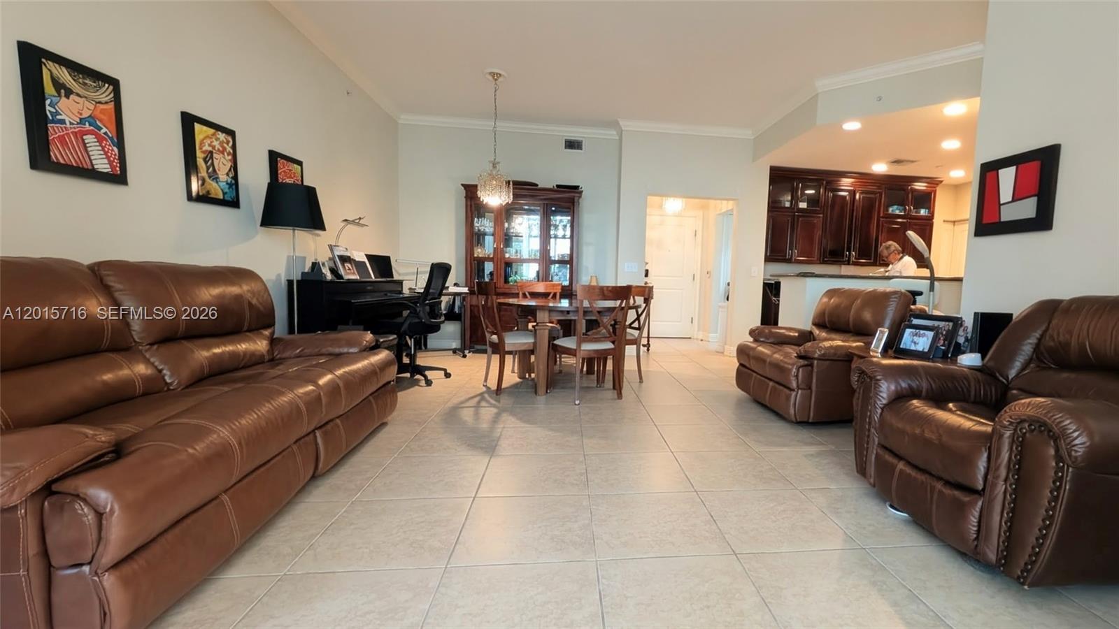 A living room features brown leather furniture, a dining set, and a piano on tile floors — 16101 Emerald Estates Dr # 254, Weston FL 33331, WESTON, FL