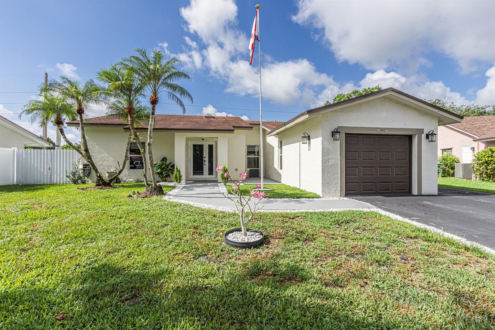 A single-story house with a white stucco exterior, brown roof, and a front-facing garage — 16942 SW 5th Way, Weston FL 33326, WESTON, FL