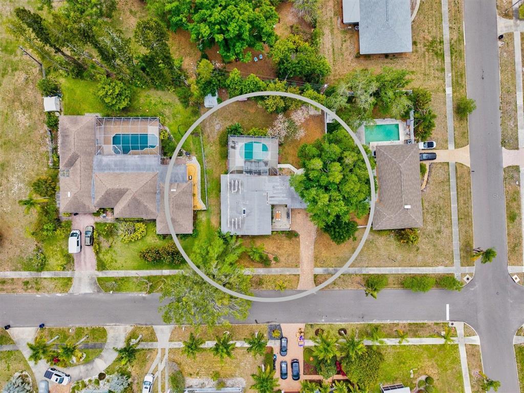An aerial view shows a residential property with a swimming pool and a large tree — 214 GAINES AVENUE, SARASOTA, FL