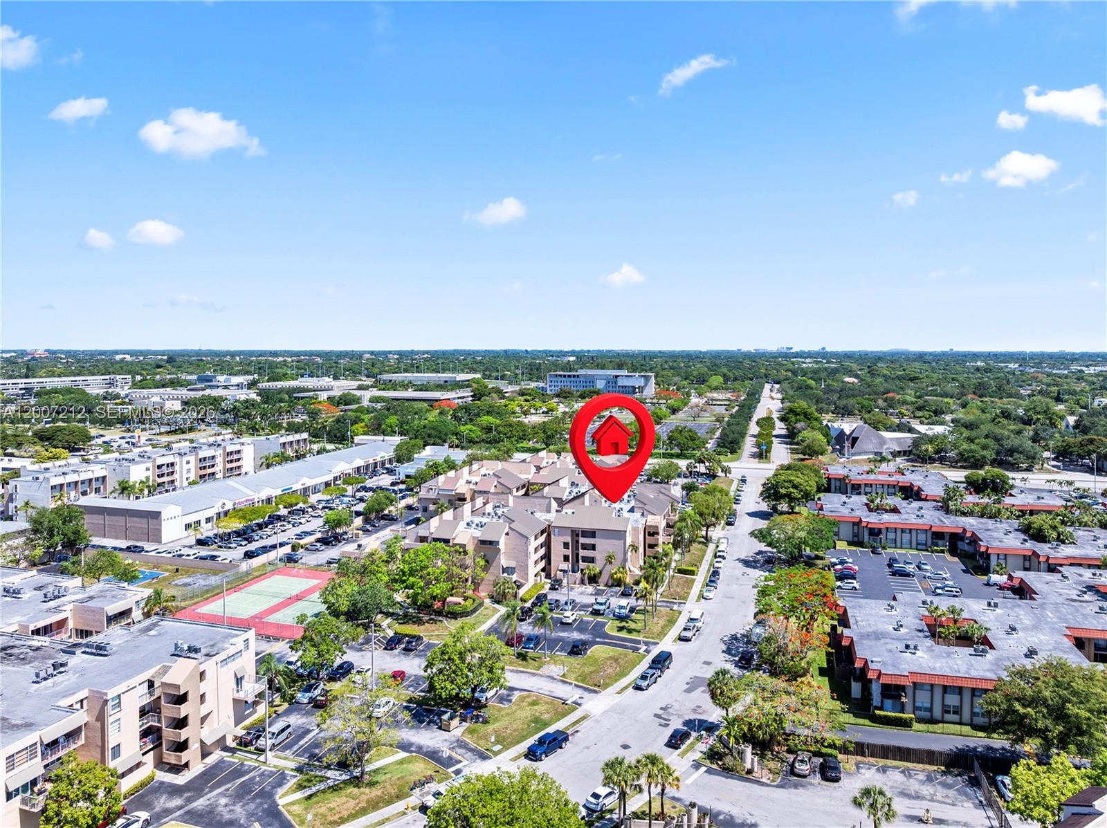 An aerial view shows a multi-story residential complex with parking lots and surrounding greenery — 10500 SW 108th Ave # B211, Miami FL 33176, MIAMI, FL