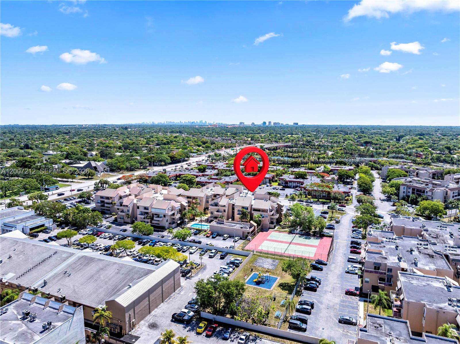 An aerial view shows a residential complex with a tennis court and a playground — 10500 SW 108th Ave # B211, Miami FL 33176, MIAMI, FL