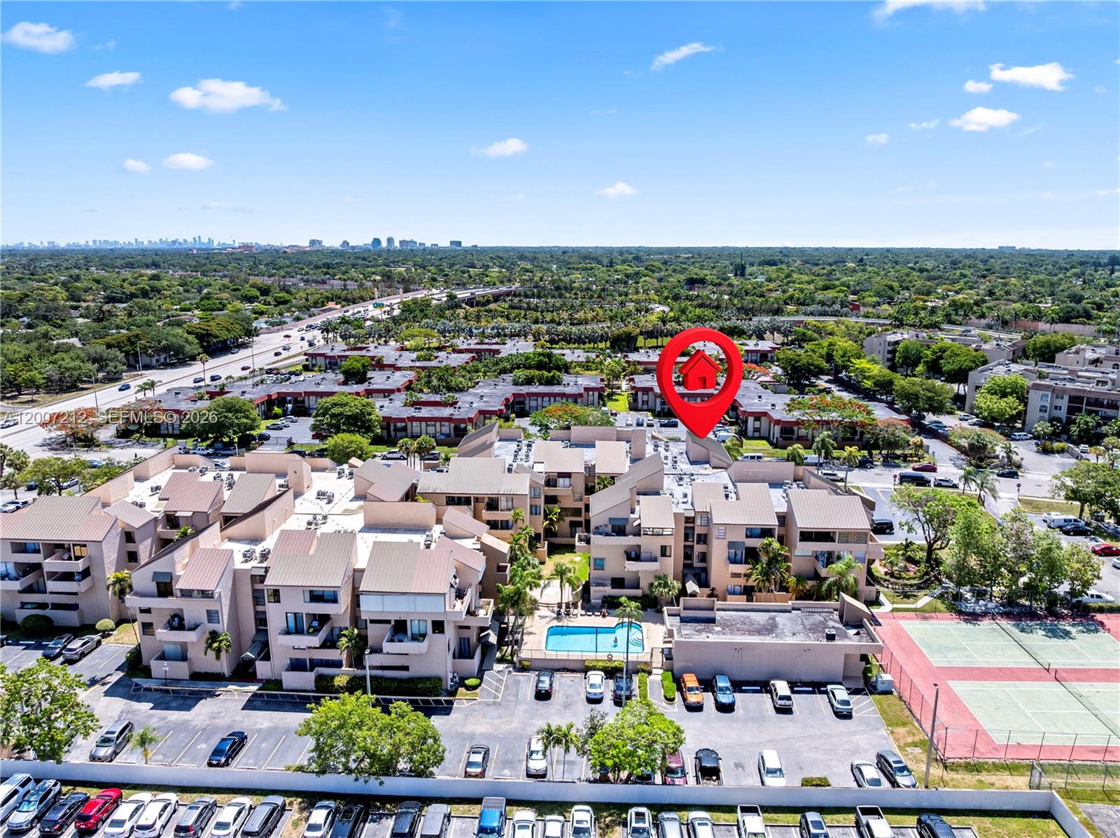An aerial view shows a multi-story residential complex with a swimming pool and parking lot — 10500 SW 108th Ave # B211, Miami FL 33176, MIAMI, FL