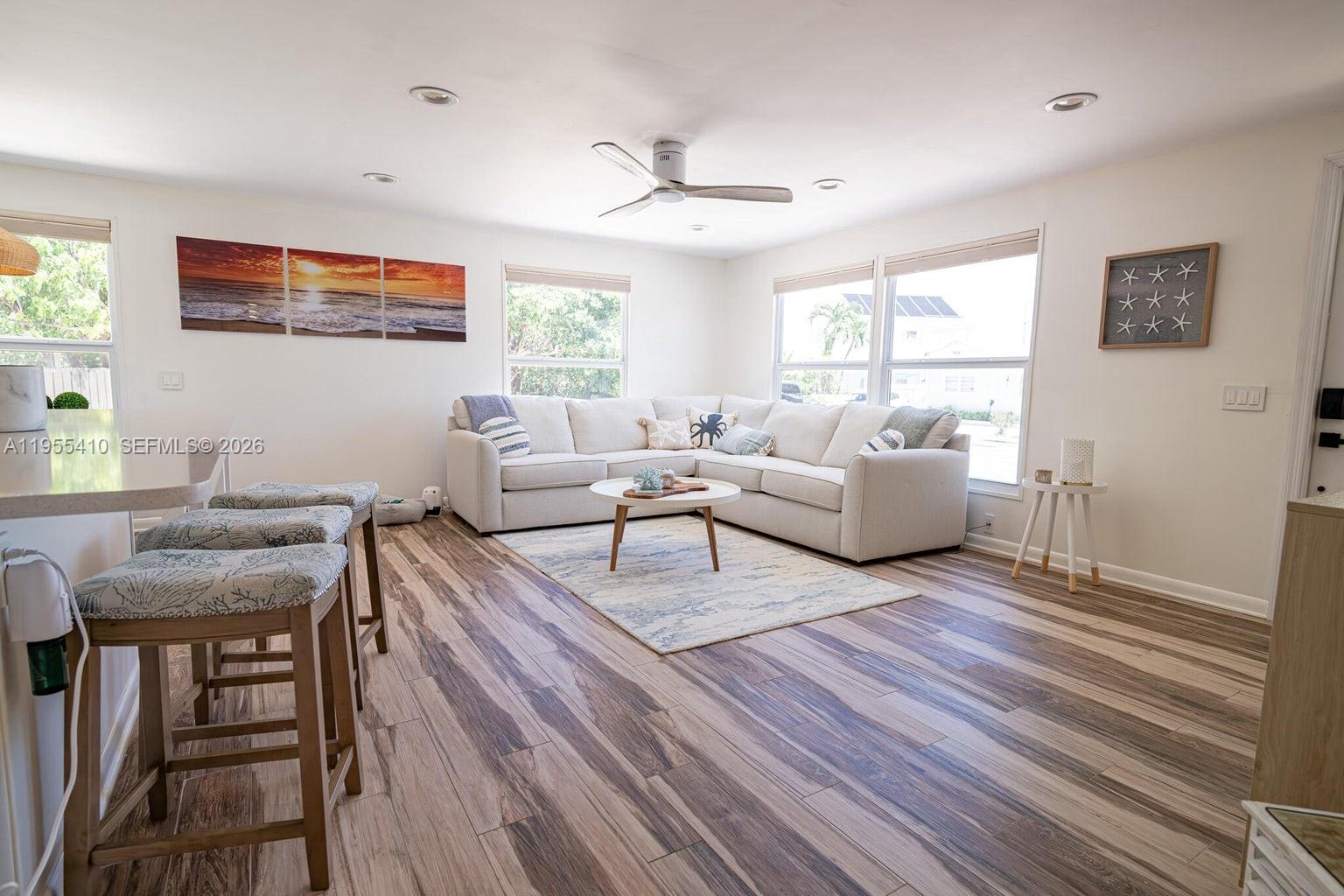 A living room features a sectional sofa, a coffee table, and wood-look tile flooring — 212 Buttonwood Ln # 212, Key Largo FL 33070, KEY LARGO, FL