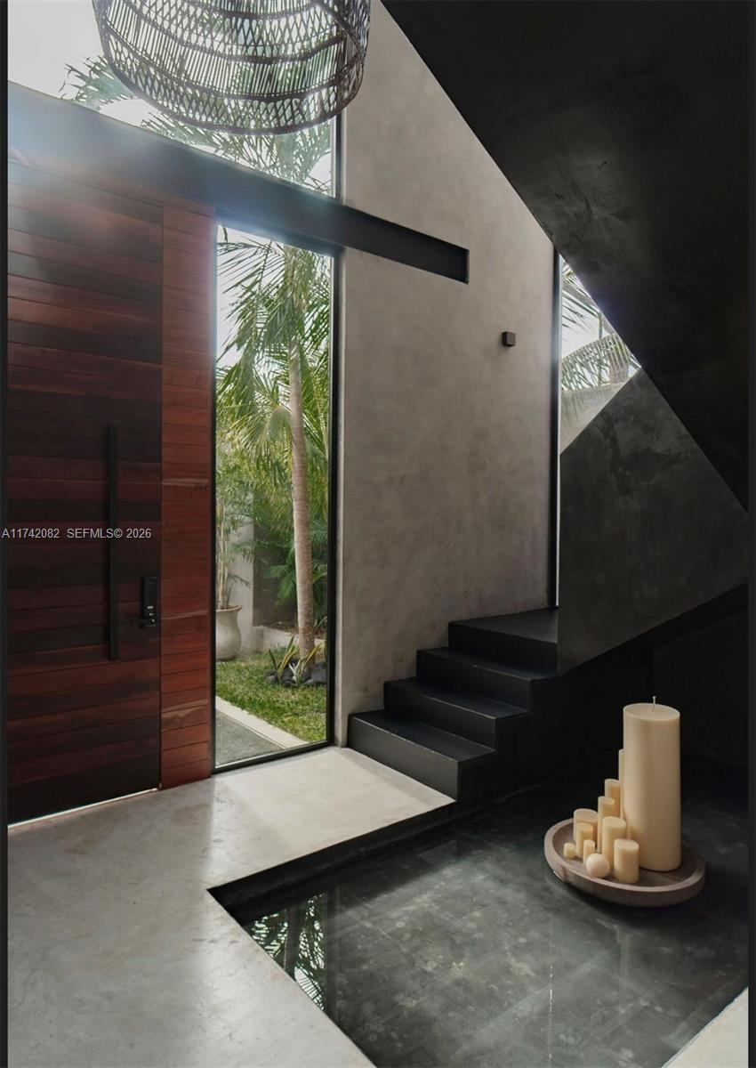 An entryway features a wooden door, a concrete floor with a water feature, and stairs — Tulum region 15 Mnz 327 lotes 007, ., .