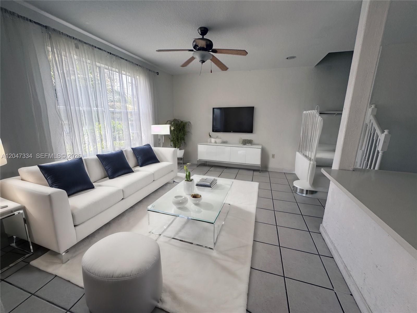 A living room features a white sofa, glass coffee table, and tile flooring — 3523 SW 169th Ter, Miramar FL 33027, MIRAMAR, FL
