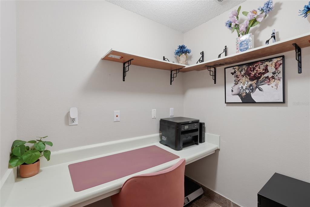 A home office nook features a built-in white desk, open shelving, and a printer — 10000 SW 52ND AVENUE UNIT 71, GAINESVILLE, FL