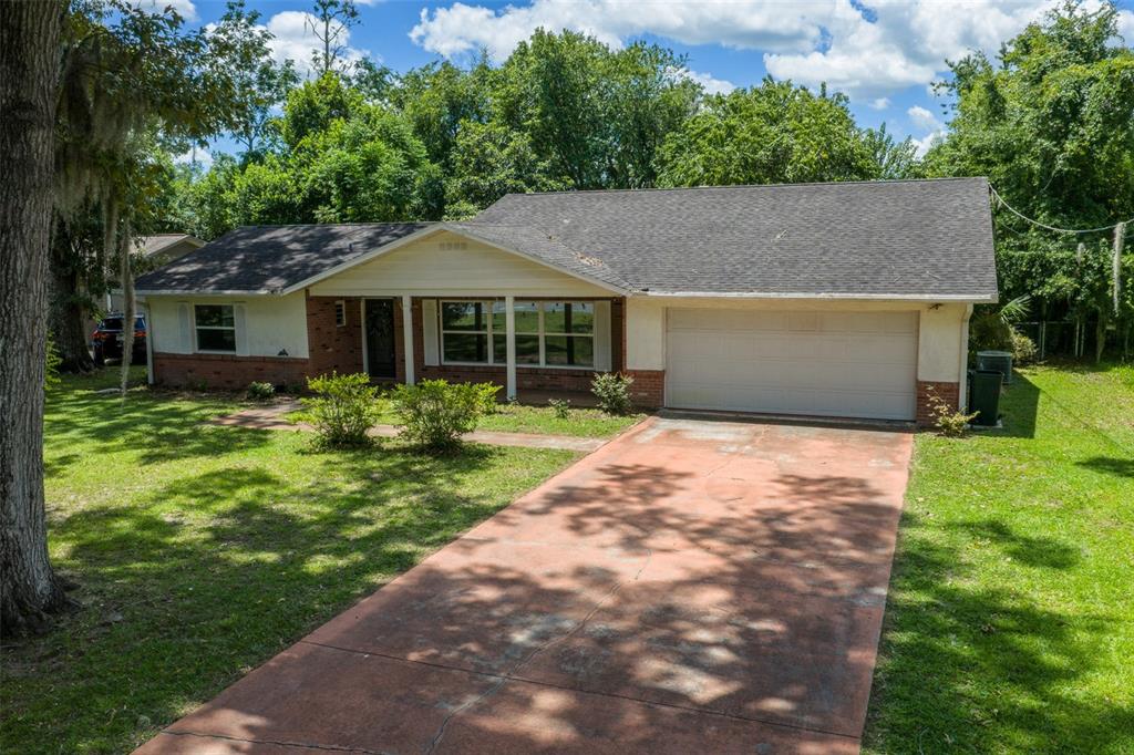 A single-story house with a brick and stucco exterior, a two-car garage, and a driveway — 1870 SE 38TH STREET, OCALA, FL