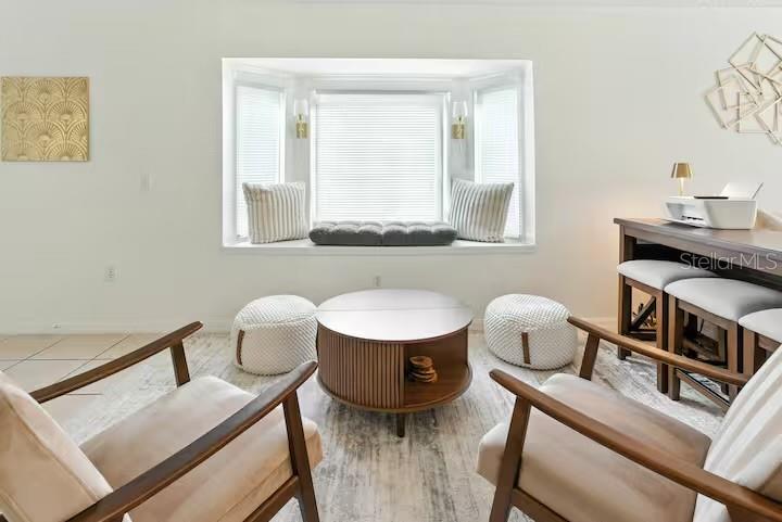 A living area features a bay window with a bench seat, two armchairs, and a table — 1017 LAKE BERKLEY DR, KISSIMMEE, FL