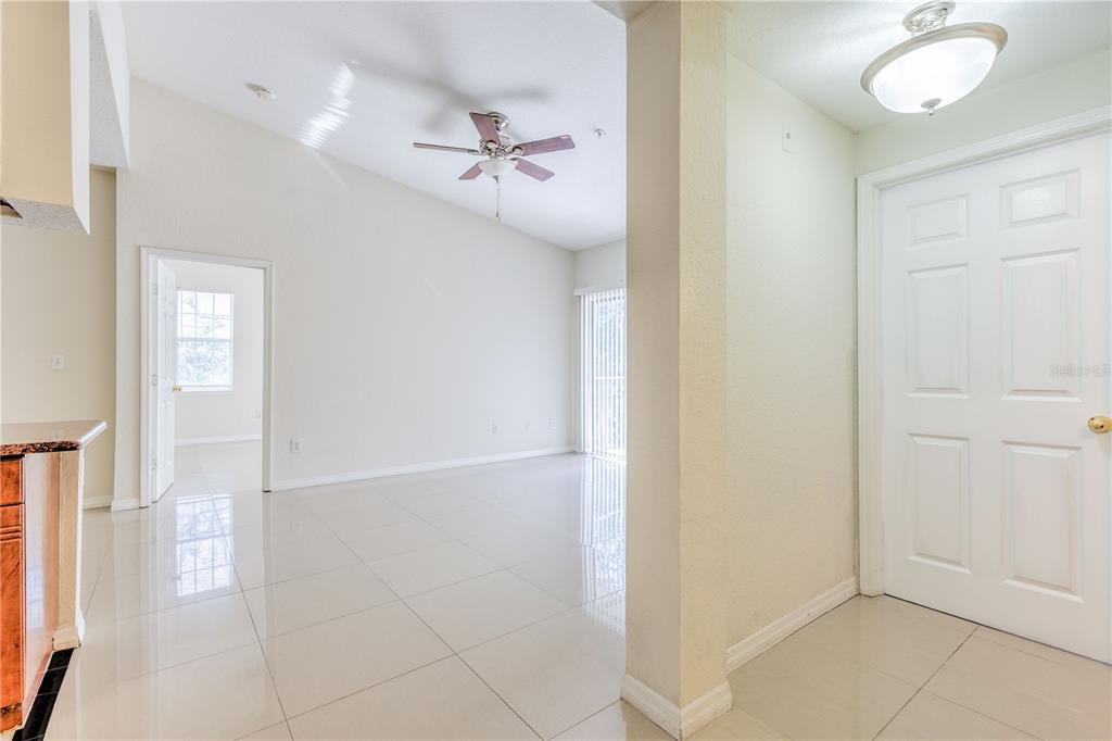 An interior view shows a tiled entryway leading into a living area with vaulted ceilings — 13304 SANCTUARY COVE DRIVE UNIT 303, TAMPA, FL