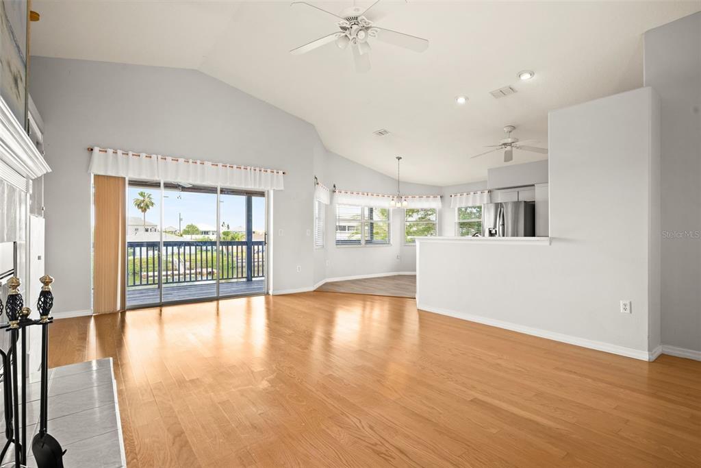 A concrete walkway leads to a private boat dock on a canal with residential homes — 4263 TAHITI DRIVE, HERNANDO BEACH, FL