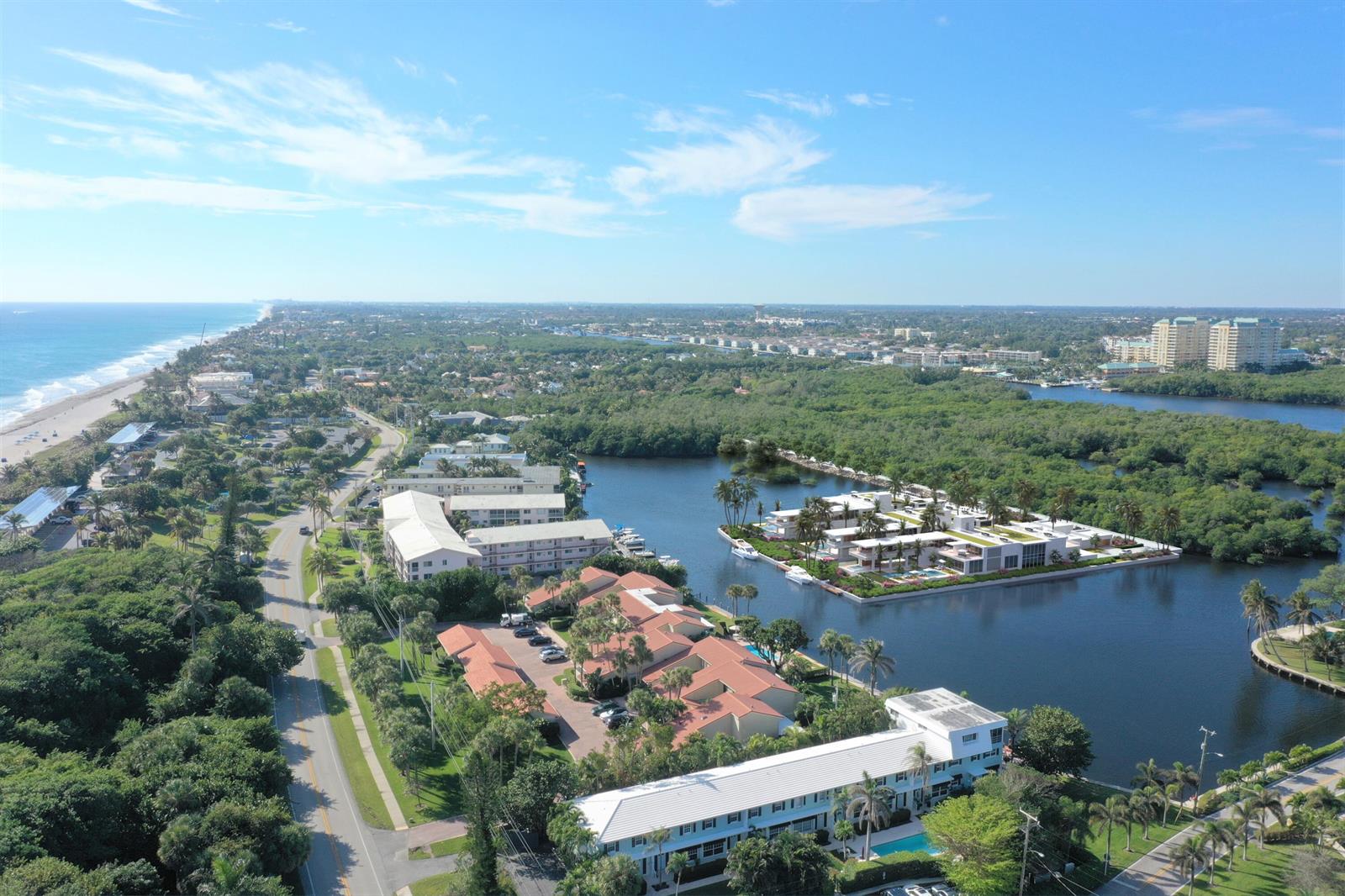 An aerial view shows coastal residential buildings, a waterway, and a beach along the ocean — 6522 N Ocean Boulevard, Ocean Ridge FL 33435, OCEAN RIDGE, FL