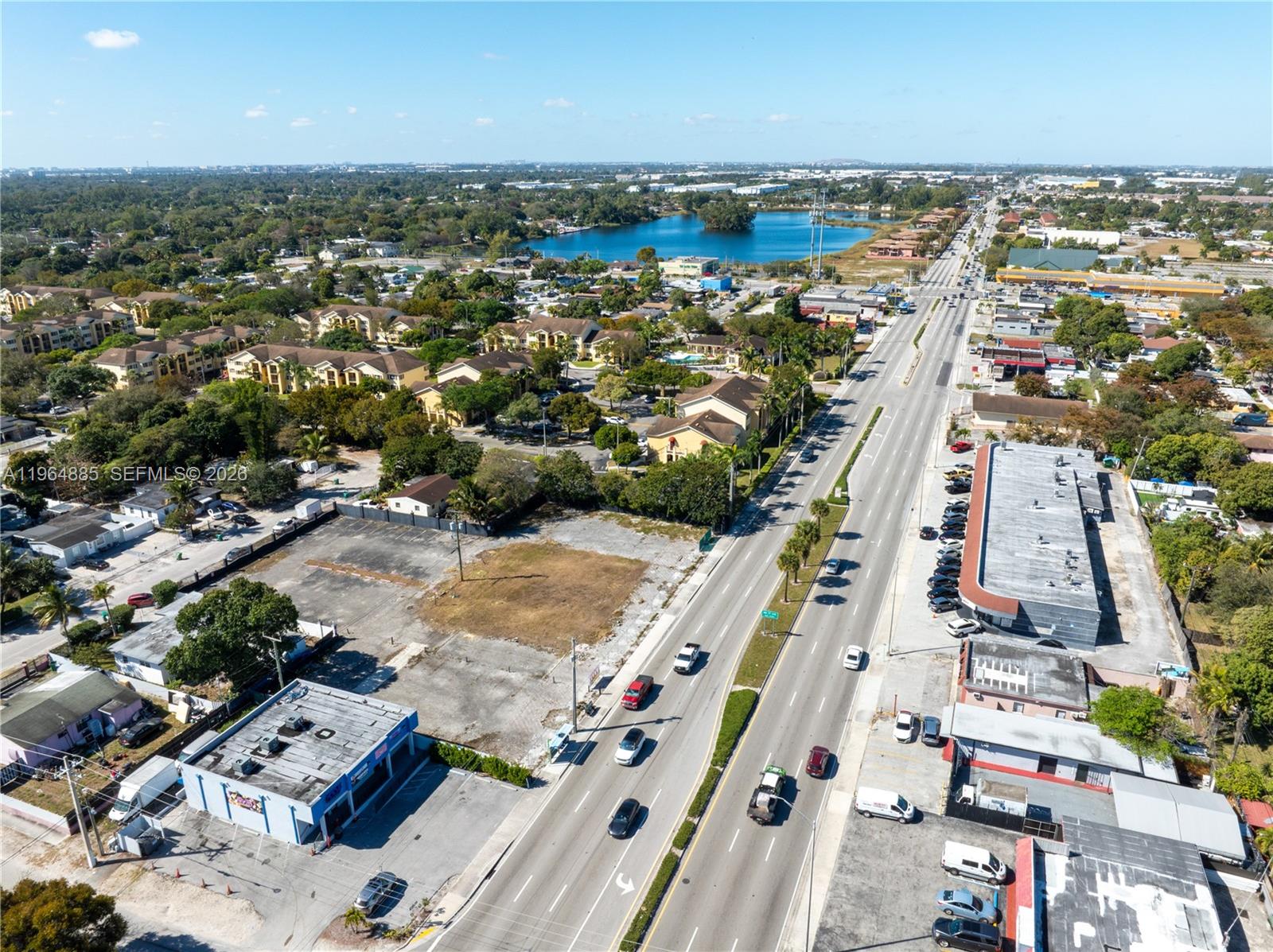 An aerial view shows a commercial lot, a multi-lane road, and surrounding residential buildings — 1410 NW 119th St, Miami FL 33167, MIAMI, FL