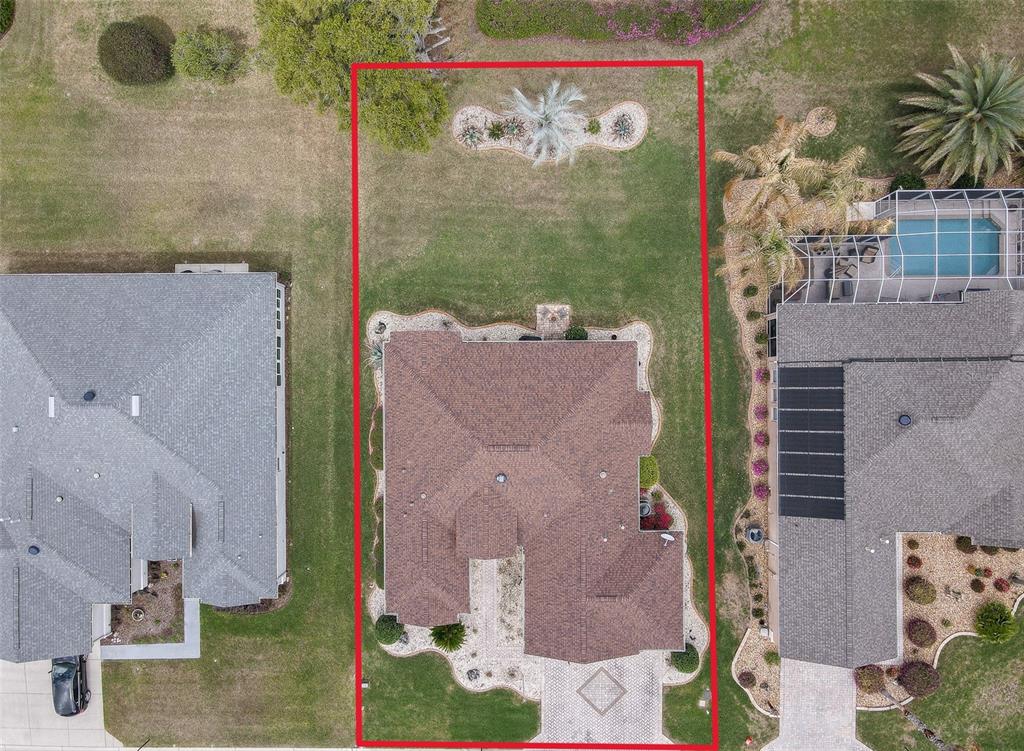 An aerial view shows a residential house with a large backyard and a paved driveway — 9435 SE 124TH PLACE, SUMMERFIELD, FL