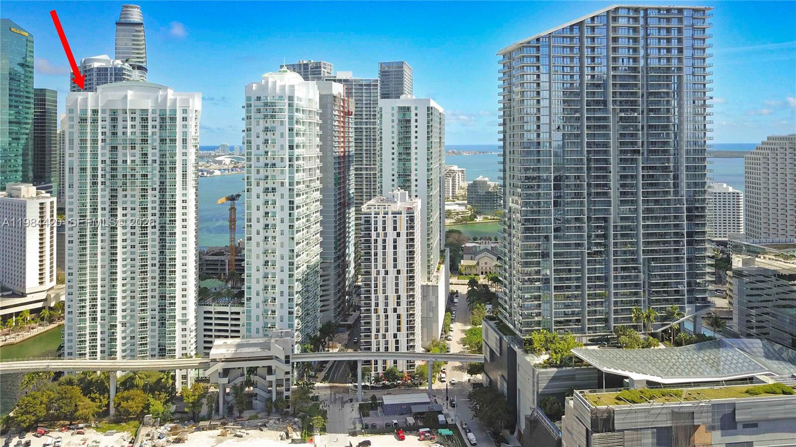 An aerial view shows high-rise residential towers in a dense urban waterfront setting — 31 SE 5th St # 3916, Miami FL 33131, MIAMI, FL
