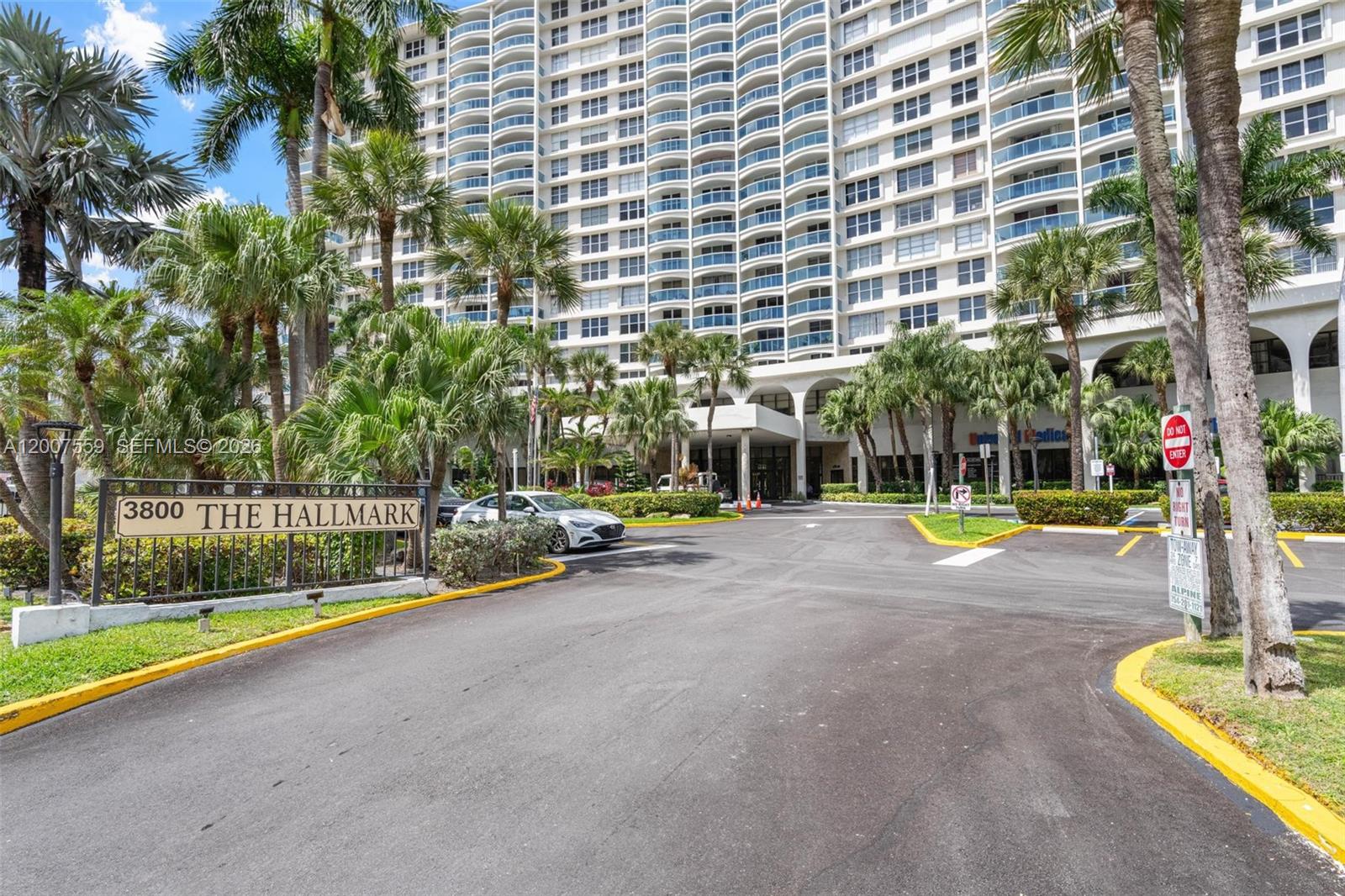 A tall residential building stands behind a paved driveway with a prominent entrance sign — 3800 S Ocean Dr # 301, Hollywood FL 33019, HOLLYWOOD, FL