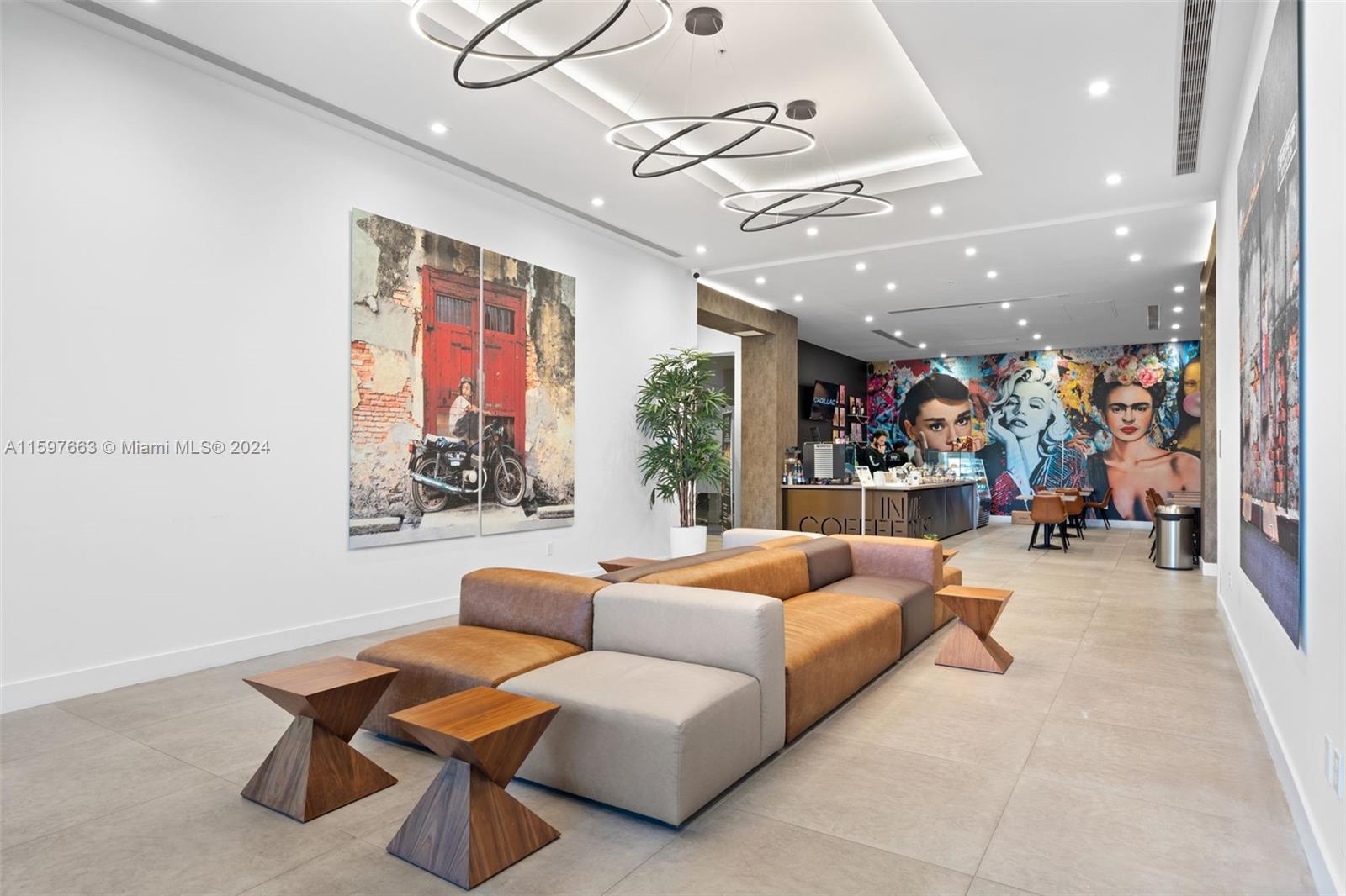 A modern lobby features modular seating, geometric side tables, and large wall art — 800 SE 4th Ave # 817, Hallandale Beach FL 33009, HALLANDALE BEACH, FL
