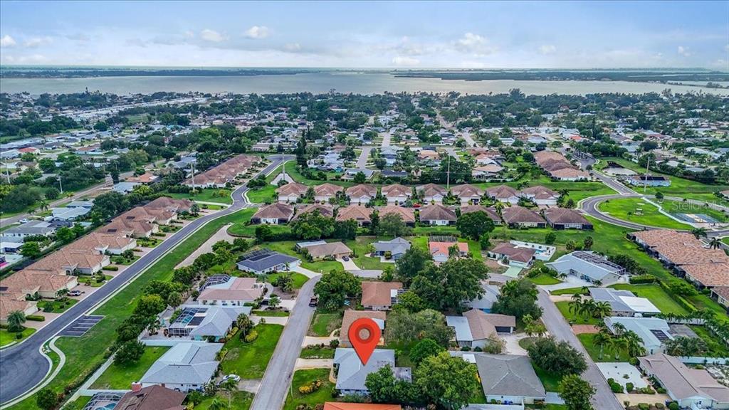 An aerial view shows a residential neighborhood with a red location pin on a house — 6814 16TH AVENUE DRIVE W, BRADENTON, FL