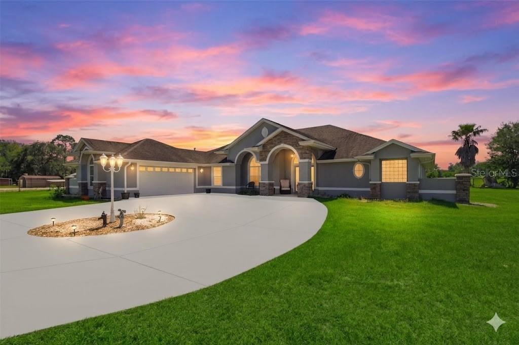 A screened-in patio features a rectangular swimming pool, lounge chairs, and outdoor seating furniture — 12764 COUNTY ROAD 223, OXFORD, FL
