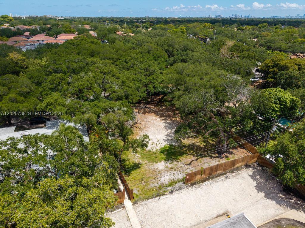 An aerial view shows a vacant, wooded residential lot bordered by a wooden fence — 5941 SW 36th Ter, Dania Beach FL 33312, DANIA BEACH, FL