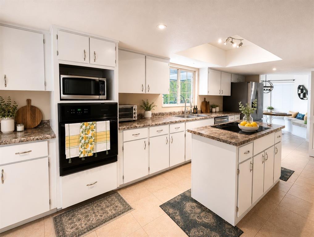 A living room features a stone fireplace, vaulted ceiling, skylight, and a large sectional sofa — 44131 PARKWAY LANE, ALTOONA, FL