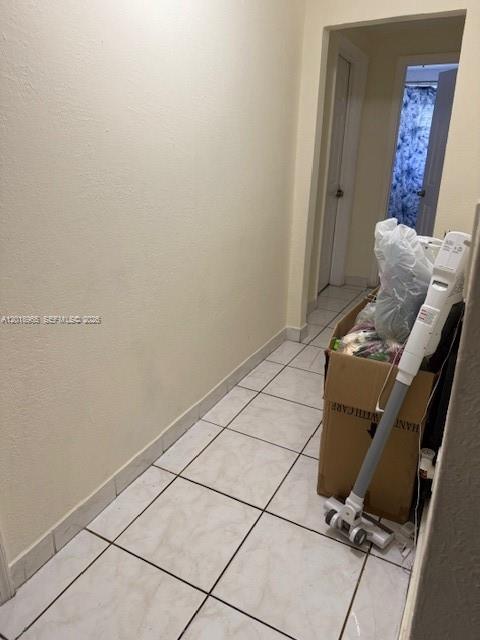 A narrow hallway features light-colored tile flooring and a cardboard box with a vacuum cleaner — 5328 SW 18TH ST, Hollywood FL 33023, HOLLYWOOD, FL