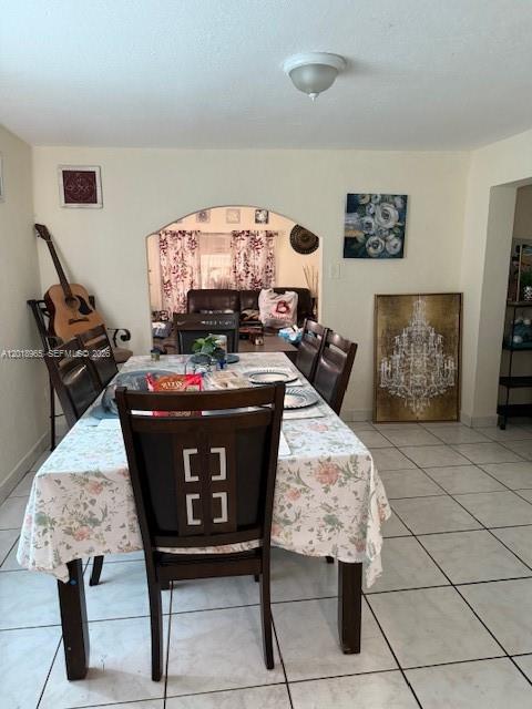 A dining room features a table with a floral tablecloth and an arched entryway — 5328 SW 18TH ST, Hollywood FL 33023, HOLLYWOOD, FL