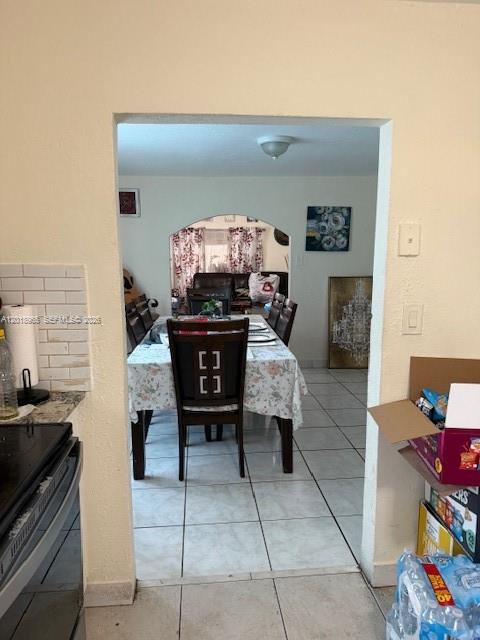 A dining room with a table and chairs is visible through an arched doorway — 5328 SW 18TH ST, Hollywood FL 33023, HOLLYWOOD, FL